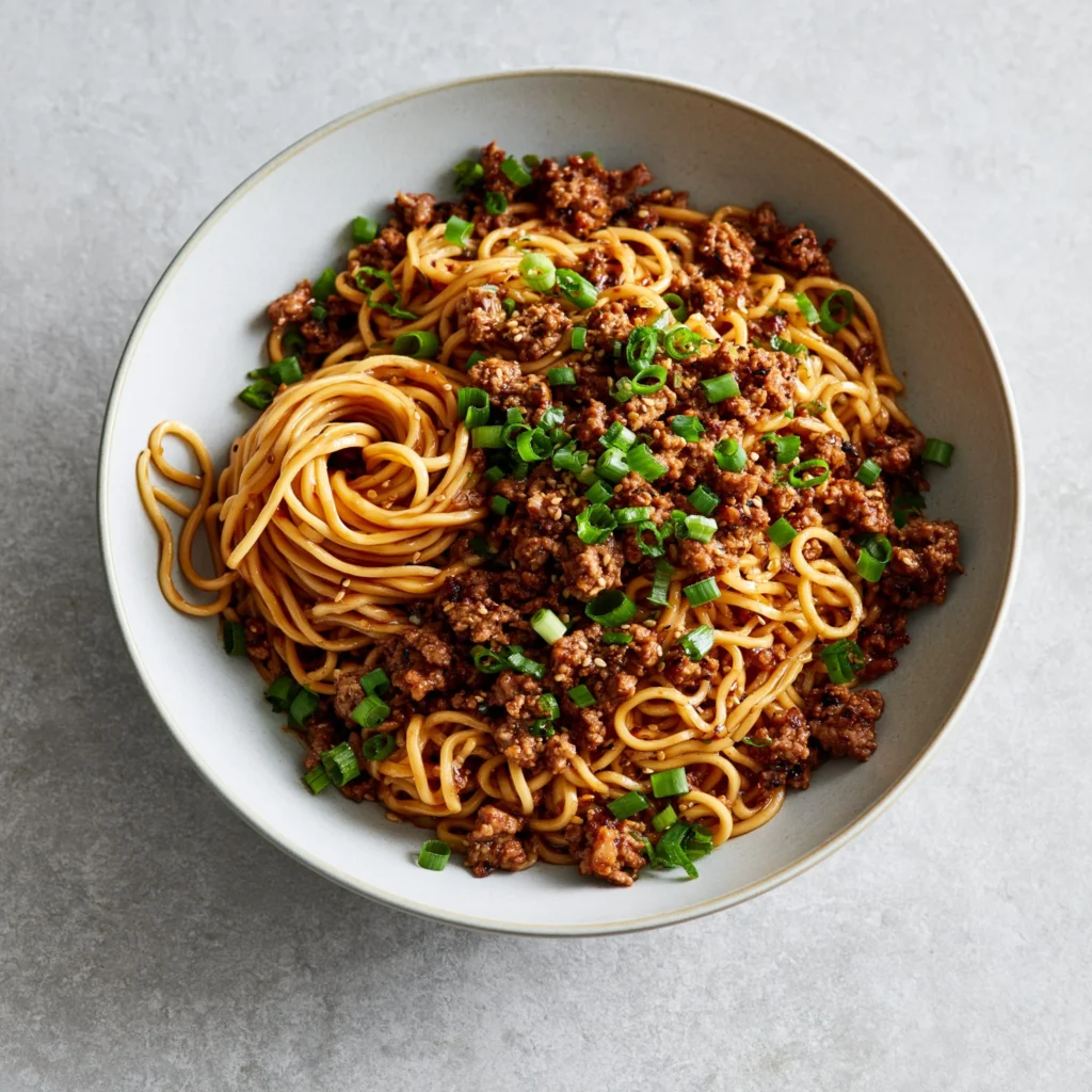 Delicious bowl of Mongolian Ground Beef Noodles with fresh ingredients.
