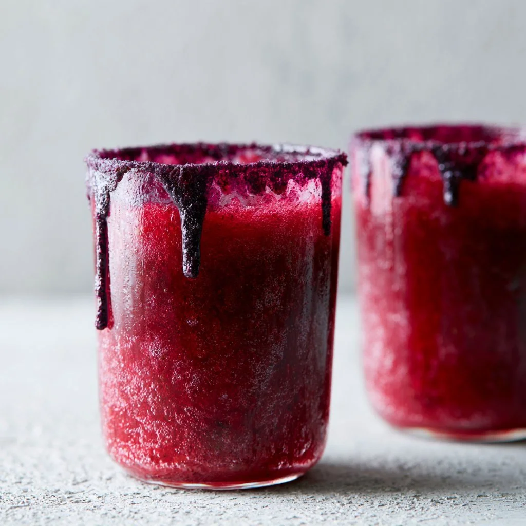 Vampire's Kiss mocktail with red fruit and spooky garnish